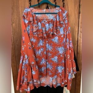 Flowy long sleeved blouse by Free People.Tag says size L but fits like 1x  NWT